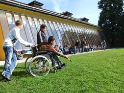 wheelchair disabled on a green sports lawn