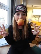 cool caucasian school girl with apple in mouth