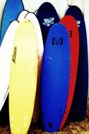 pile of colorful Surfboards