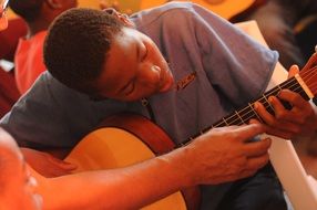 black guy learns to play guitar