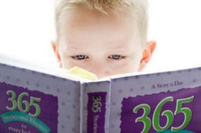 Looking child into a book