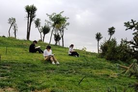 students with textbooks in the park