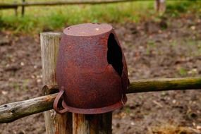 old pitcher on fence post