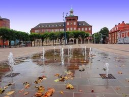 square with fountains among the city in autumn