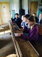 children at their desks in the school museum in Sweden