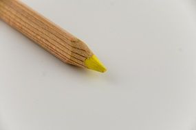 the sharpened edge of a yellow pencil