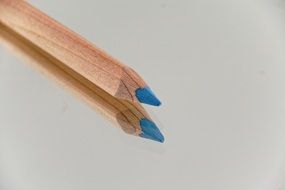 sharpened edge of pencil with blue core on the mirror surface