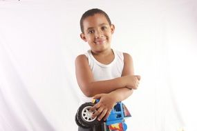 portrait of the happy boy with toy truck