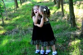 small twin sisters together outdoor
