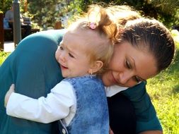 touching hugs mom and daughter