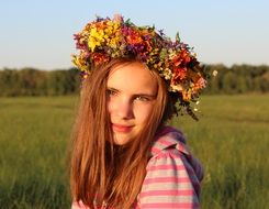 portrait of red-haired girl with a wreath on her head