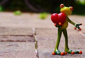 ceramic figure of a frog with a heart