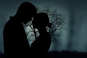 clipart of couple in love on a background of a tree in the dark