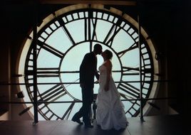 bride and groom kissing in clock tower