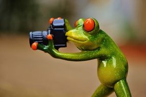 green ceramic frog with camera