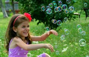 small girl with soap bubbles