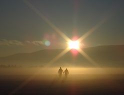 couple in love holding hands on sunset background