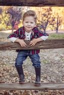 boy on a wooden fence