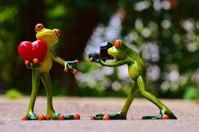 Two figures of green frogs