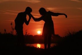 the shade of the loving couple near the water