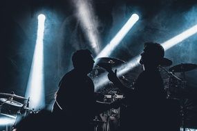 rock musicians with guitar on stage