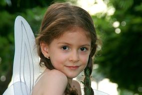 portrait of a child in a suit with wings