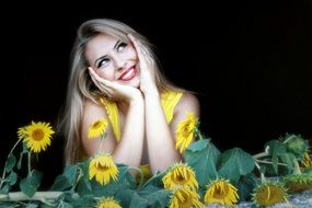 happy girl among sunflowers