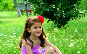 Girl with a smile on the background of soap bubbles