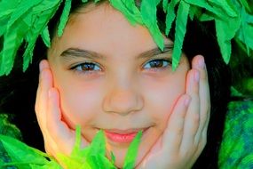 portrait of girls behind green leaves