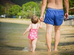 father and daughter on the beach