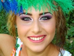 girl with beautiful make-up and different feathers on her head