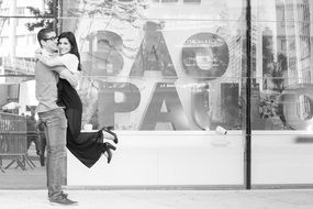 couple hugging near the store