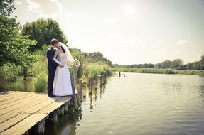 ewlyweds on a wooden quay