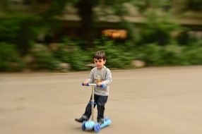 Boy staying on scooter