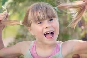 Little girl with tails smiling