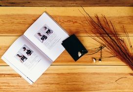 magazine and phone on a wooden table