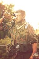 military man with weapon against nature