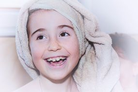 lauthing girl wiyh towel on head