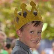 child in the crown is smiling