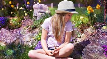 happy girl sitting on the stone