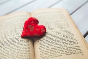 red heart on a vintage book