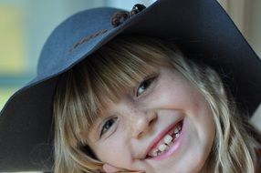 laughing little girl in a hat