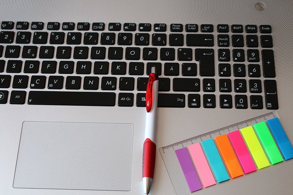 pen and colored stickers on the laptop