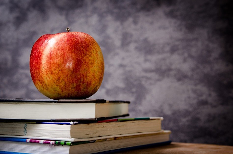 red apple and books on the table