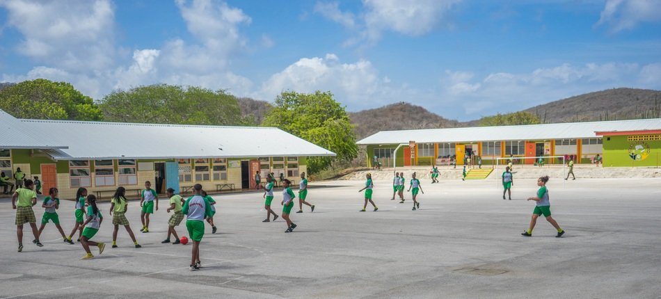 Children in uniform play in the schoolyard