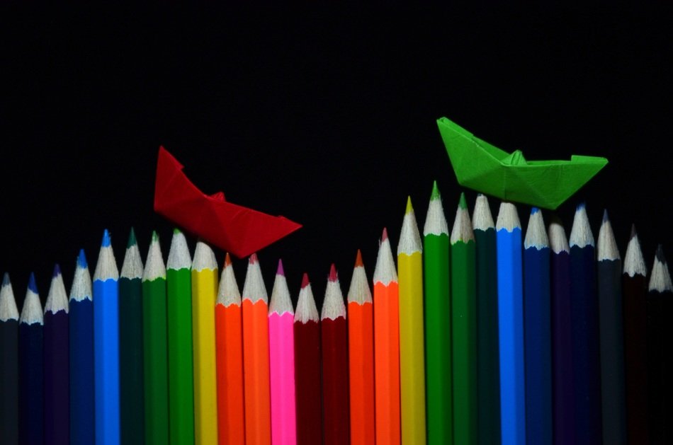 colored pencils with peper ships
