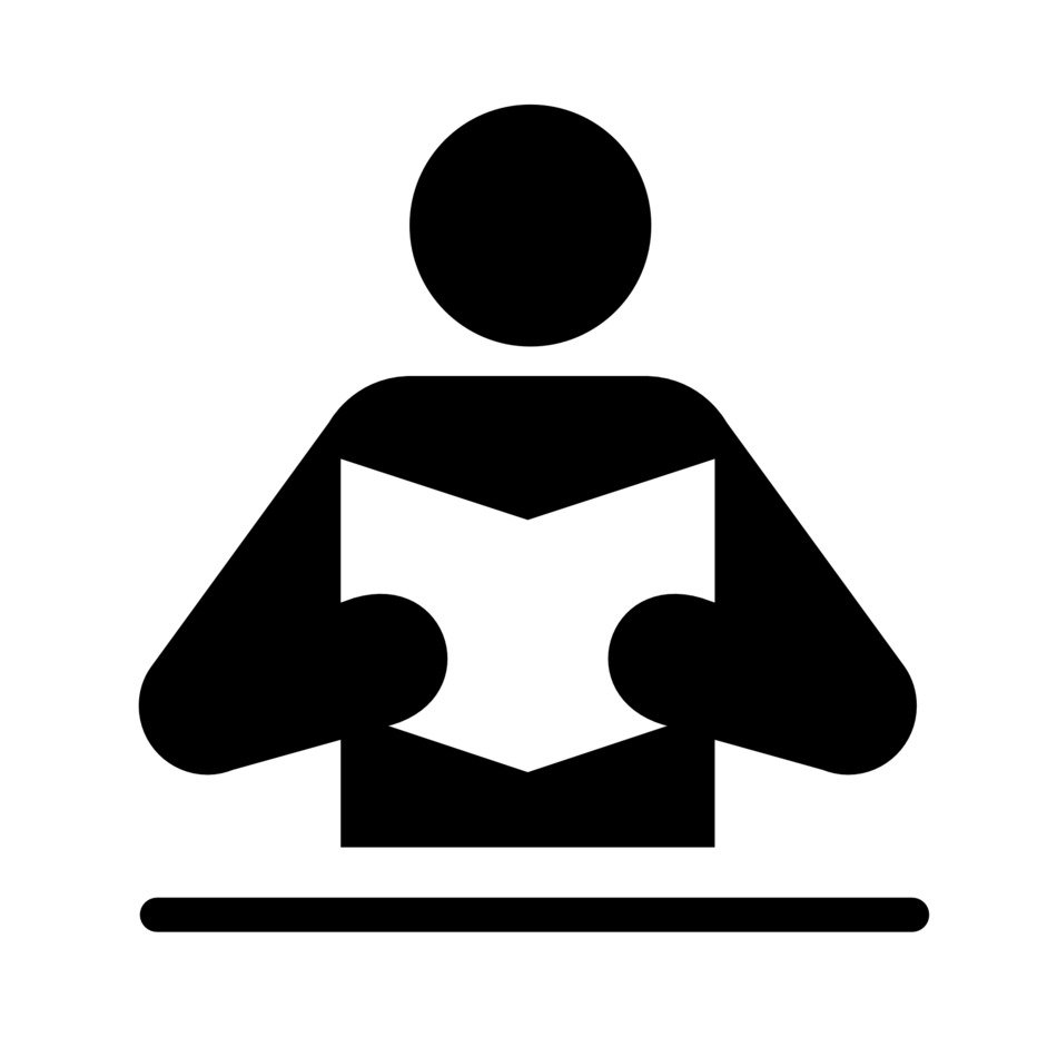 figure of a man at the table with a book