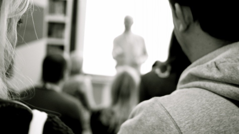 students in the audience in the blurred background