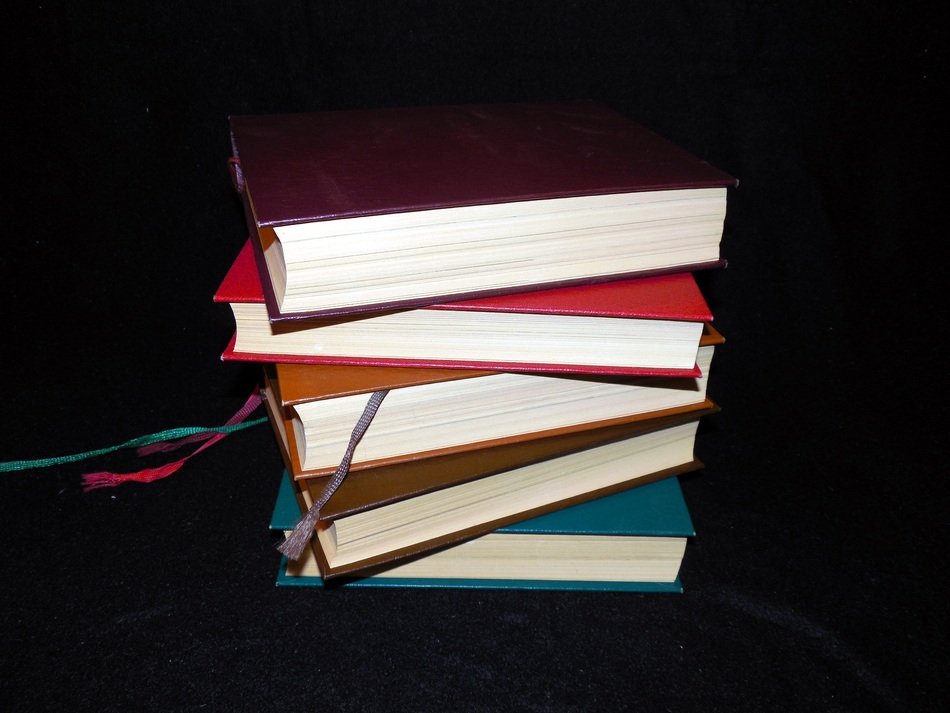 books with colored endpapers on a black background