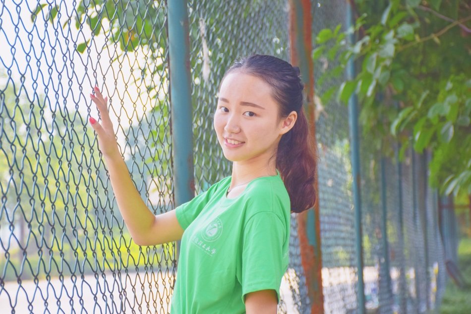 Asian long haired Girl near metal fence